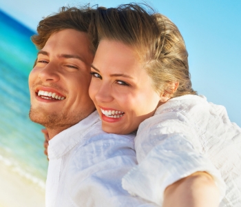 happy man and woman at the beach
